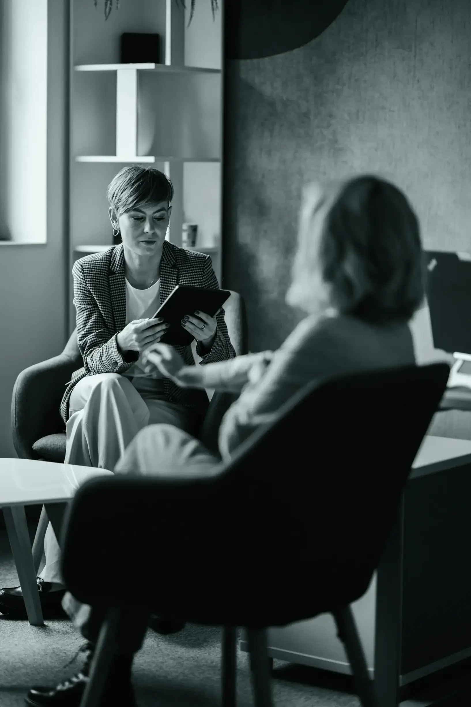 Female therapist using tablet with patient